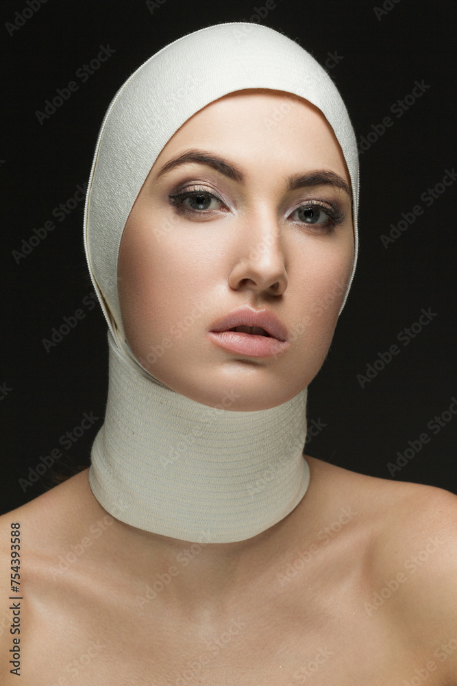 Beautiful woman after plastic surgery with bandaged face. Beauty, Fashion and Plastic Surgery concept Beautiful woman after plastic surgery with bandaged face. Beauty, Fashion and Plastic Surgery concept