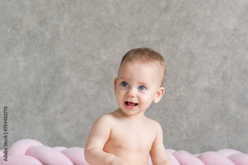 The cheerful face of a sitting baby. Close-up