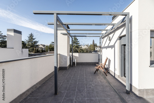 A gray painted metal pergola located in the attic of a home