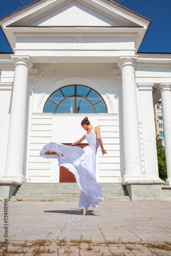 Portrait of a Russian ballerina in a white long skirt photo