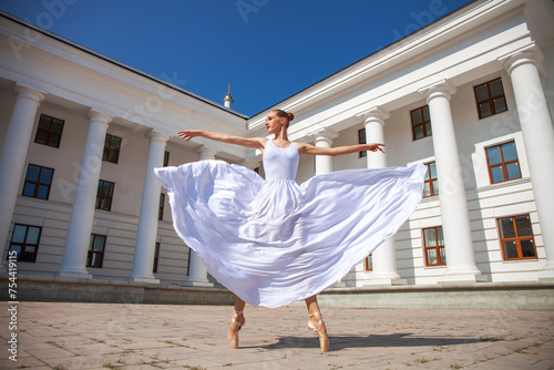 Portrait of a Russian ballerina in a white long skirt photo