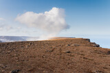Rocky landscape with beautiful cumulus cloud formed on top of Bolafjall mountain, Westfjords, Iceland