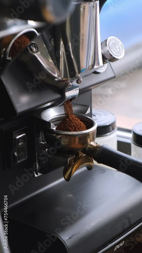 The barista makes coffee, grinds coffee in a coffee grinder, pours espresso, whips milk with a steamer, pours cappuccino and latte with a heart. The coffee machine is making an espresso. Failure