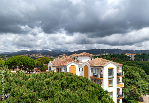Rain clouds on the Pyrenees mountains and a beautiful landscape with blooming pine trees in Elviria, Marbella. Spain