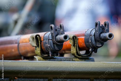 Lee Enfield Rifles. A close up view of the muzzles and sights of two second world war era rifles. 