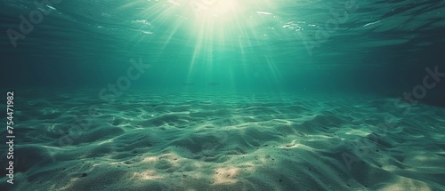  an underwater view of sand and water with the sun shining over the top of the water and the bottom of the water.
