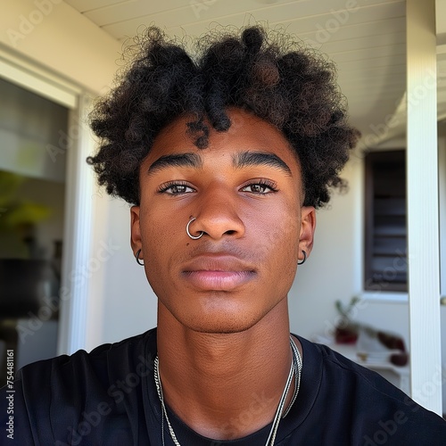 A close-up portrait focusing on a Cape Verdean man wearing a stylish necklace, displaying intricate details and raw elegance. photo