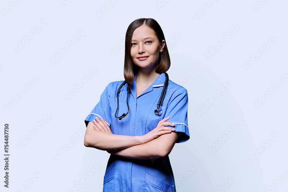Portrait of young female nurse looking at camera on white background Portrait of young female nurse looking at camera on white background
