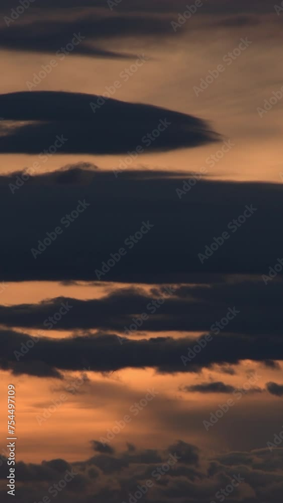 Clouds moving in the sky at sunset. 4K Vertical