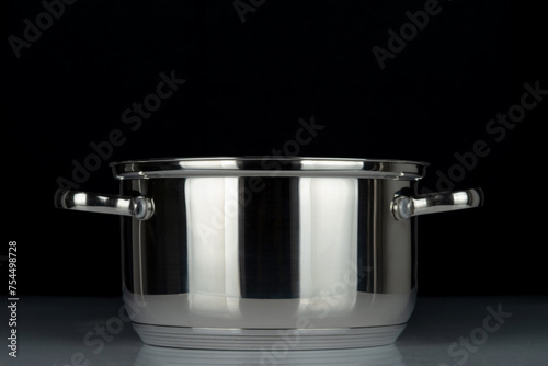 Stainless steel pan isolated on black background..