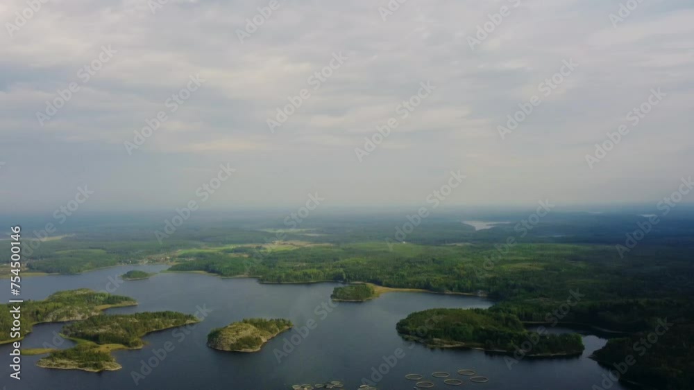 Russia, Lake Ladoga, Koyonsaari. View of the coast of the island in a cold lake. Beautiful nature of the Republic of Karelia. Panoramic view from the height of the Ladoga skerry islands. 4K