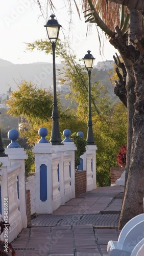 Typical andalusian street at sunset. Maro, Nerja, Spain. 4K Vertical photo