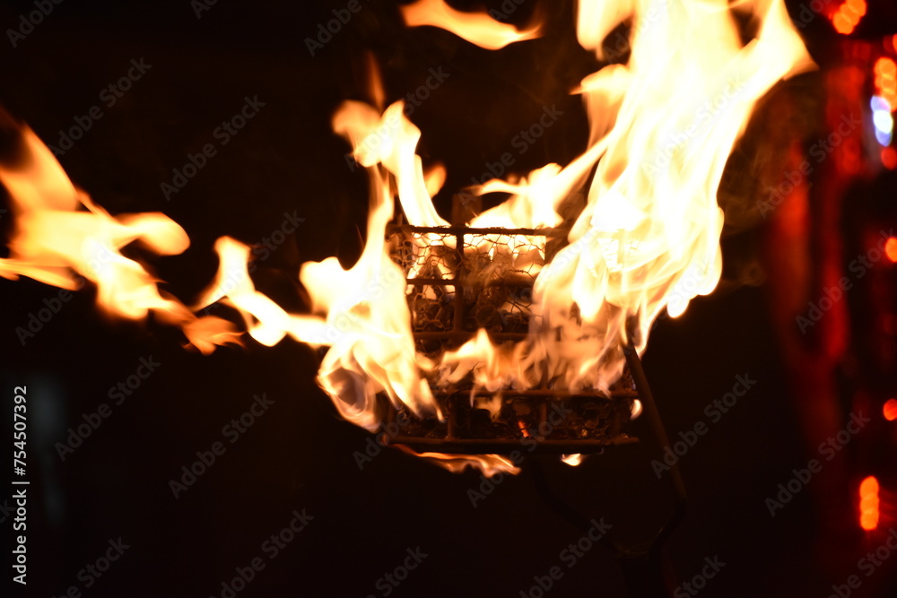 Naklejka premium Flames of a coppara torch that lighting in Kandy Esala Perahera at Temple of the Tooth (Sri Dalada Maligawa), Kandy, Sri Lanka.