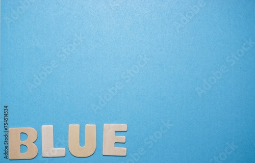 Fotografie Wooden Letters Spelling Blue on a Blue background