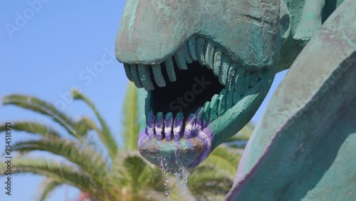Dragon statue streams water in sunny Gran Canaria in 4k slow motion 120fps photo