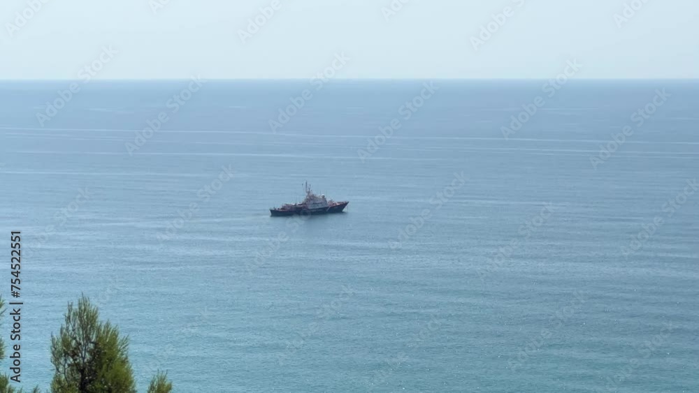 View of the Black Sea and passing ships. Stunning views of the blue lagoon, juniper forest, the surroundings of Bolshoy Utrish and Sukko. View from the mountain to the sea on a sunny day. View of the Black Sea and passing ships. Stunning views of the blue lagoon, juniper forest, the surroundings of Bolshoy Utrish and Sukko. View from the mountain to the sea on a sunny day.