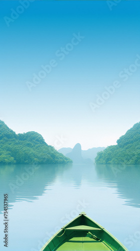 The image is of a boat on a lake with green mountains in the background. The sky is blue and the water is green. The image is in the style of realism. © zhor