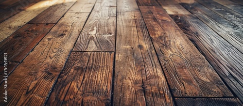 Detailed view of the weathered and aged wooden floor in a room, showing grain patterns, knots, and wear marks up close.
