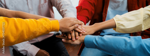 Startup company employee team stacking hand together symbolize successful group of business partnership and strong collective unity teamwork in community workplace in panoramic banner. Synergic