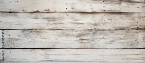 A detailed view of an old white wooden wall, showcasing the texture and color variations of the weathered wood planks up close.