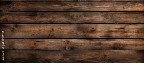 A wooden wall painted in a rich brown hue, showing the natural grain of the wood. The paint has been evenly applied, giving a uniform appearance to the wall.