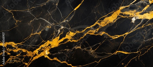 This wallpaper features a luxurious black and gold marble pattern on a black background. The gold veins in the marble stand out against the dark backdrop, creating a sophisticated and elegant design.