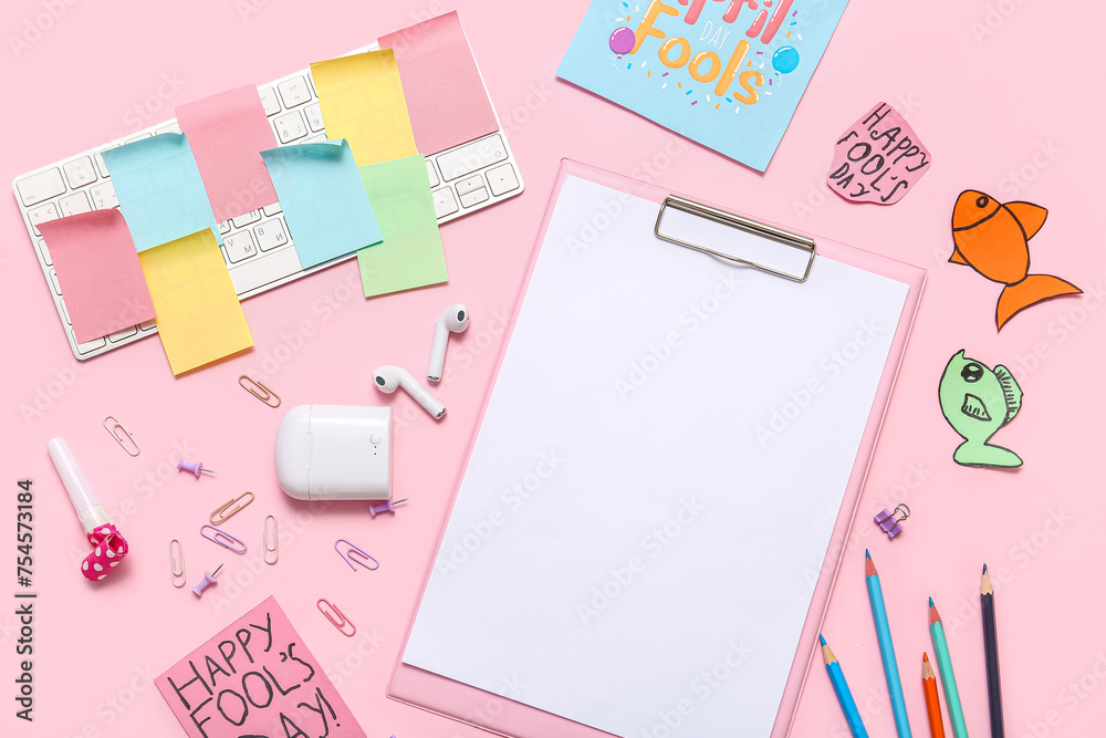 Clipboard, stationery and sticky notes on pink background. April Fools Day prank Clipboard, stationery and sticky notes on pink background. April Fools Day prank