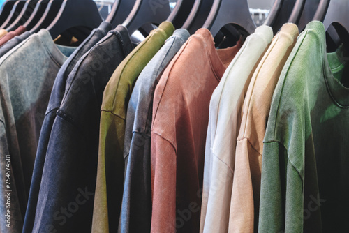 Multicolor family clothes on hangers in store, sale concept background, retail, marketing and merchandising concept background