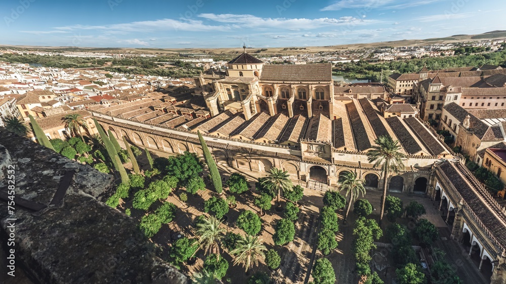 Panoramic aerial view of Mosque Cathedral of Cordoba and Patio de los Naranjos Courtyard - Cordoba, Andalusia, Spain from the bell tower of the cathedral