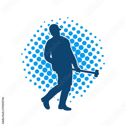 Silhouette of a worker in action pose using his sledge hammer tool.