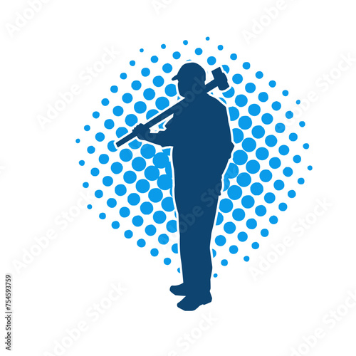 Silhouette of a worker in action pose using his sledge hammer tool.