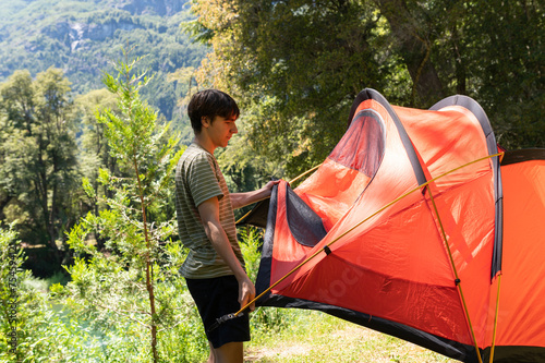 Young boy preparing the camping tent on his summer vacation in southern Argentina. photo