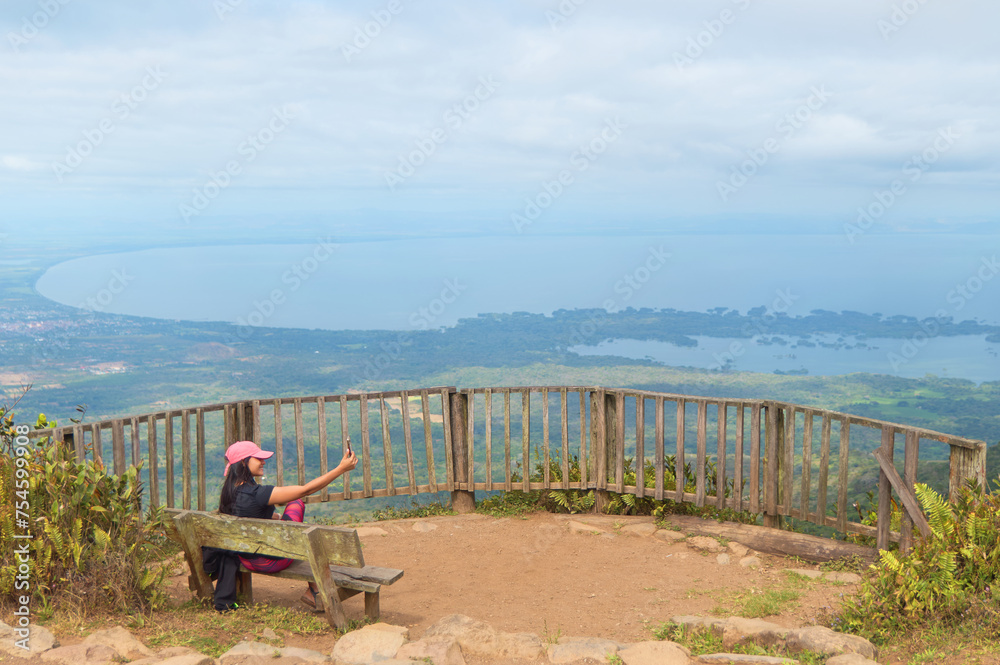 Woman taking a selfie at a lookout point at the mombacho volcano nature reserve