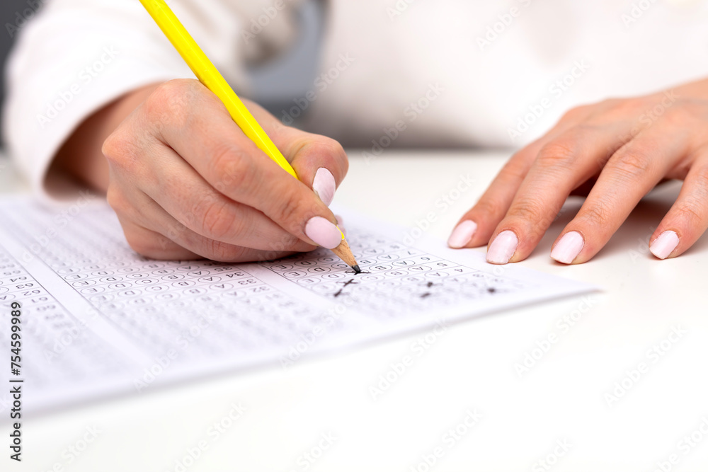 Hand filling in an Examination form. Hand filling in an Examination form.