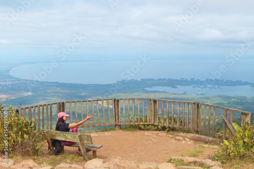 Woman taking a selfie at a lookout point at the mombacho volcano nature reserve photo