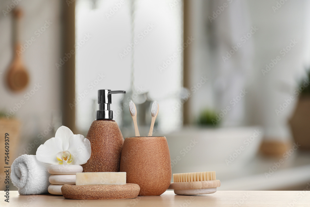 Bath accessories. Different personal care products and flower on wooden table in bathroom, space for text Bath accessories. Different personal care products and flower on wooden table in bathroom, space for text
