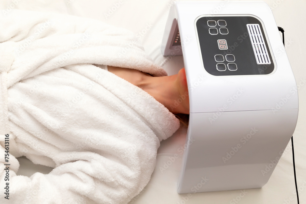 Top View Home Skin Care Procedure. Cosmetic Led Light Face Mask. Woman Lying Under Facial Regenerative Treatment Mask On Bed In Bedroom. Acne, Spot Cure. Beauty Photon Therapy. Horizontal Plane Top View Home Skin Care Procedure. Cosmetic Led Light Face Mask. Woman Lying Under Facial Regenerative Treatment Mask On Bed In Bedroom. Acne, Spot Cure. Beauty Photon Therapy. Horizontal Plane