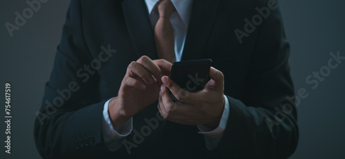 Close-up shot of an man hand using smartphone, chatting with someone or scrolling on phone while relaxing. online communication technology concept.