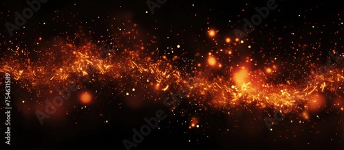The image showcases a striking orange and black background filled with numerous stars, creating a visually captivating and dynamic scene. The contrast between the fiery orange hues and the deep black