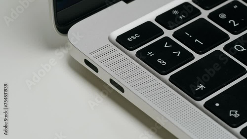 Wallpaper Mural Opening grey laptop on whte background close-up. Charging connection to computer. Phone charging port. USB wire for devices Torontodigital.ca