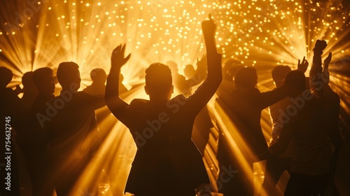 Silhouette of a group of joyous excited men dancing in luxury trendy club for an afterwork party with golden lightSilhouette of a group of joyous excited men dancing in luxury trendy club for an after photo
