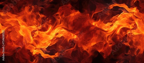 A detailed view of a roaring fire, with vivid red and yellow flames reaching high and flickering wildly. The flames create a dynamic and intense texture in the background.