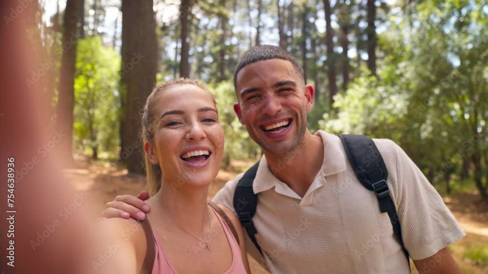 POV shot of young active couple wearing backpacks hiking along trail recording video or making video call on mobile phone in summer forest countryside - shot in slow motion POV shot of young active couple wearing backpacks hiking along trail recording video or making video call on mobile phone in summer forest countryside - shot in slow motion