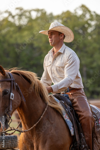 closeup of Cowboy Horse Trainer on a sorrel horse photo