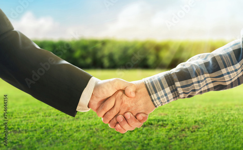 Business concept. Business handshake land purchase. Empty dry cracked swamp reclamation soil in real estate sale or property investment concept. Agriculture land plot for sales.