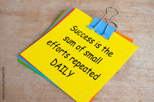 Success is a sum of small efforts repeated daily text on yellow notepad. Encouragement concept photo