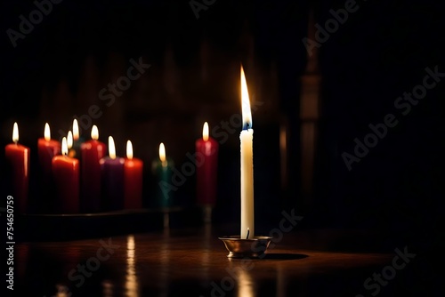 Candles in dark room in different colors in a house.