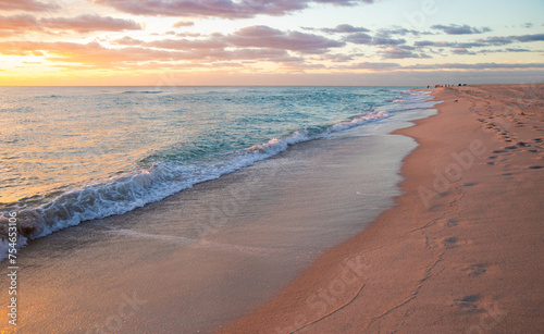 Anazing ocean beach sunrise with deep golden sky and sun rays photo