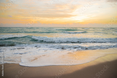 Idyllic sunrise over the ocean, water surface in slow motion during sunrise