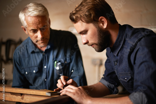 Man, dad and coach with wood, workshop and family business or apprenticeship. Father, adult son and design with artisan, carpentry and together for startup or mentor with learning and working photo